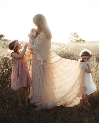 We Are Reclamation Wonderment and Awe Gown: One Size Family Photoshoot Dress Hire - Sheer Family Photoshoot dress - Shimmering Beige with Pink Hue Family Photoshoot Dress - Plunge Neckline Family Photoshoot Dress - V Neckline Photoshoot Dress - Flowy Family Photoshoot Dress Hire - Bump friendly family photoshoot dress - breastfeeding friendly family photoshoot dress - Soft Pleated Chiffon Family Photoshoot Dress - Reclamation Gown for Family Photoshoot
