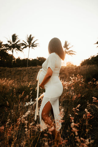 Beautiful pregnant mama wears the Hazel and Folk Melody Maxi in buttercream