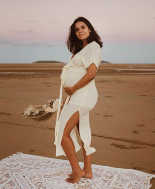 Beautiful pregnant mama wears the Hazel and Folk Melody Maxi in buttercream