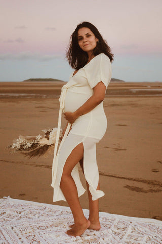 Beautiful pregnant mama wears the Hazel and Folk Melody Maxi in buttercream