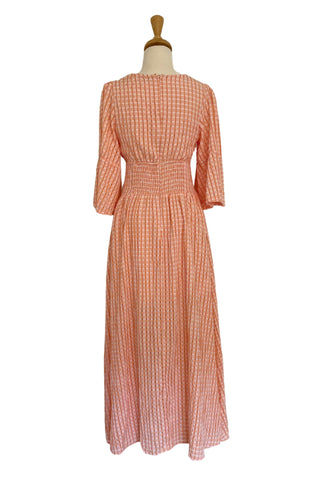 Mama Rentals Chantel Peach Maxi Dress in a mannequin showing the back of the dress