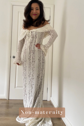 Woman wearing a lace off-shoulder dress standing in a room with a white door.