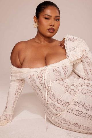 A plus size lady wearing the House of CB Belle Vintage Cream Floral Lace Off Shoulder Maxi Dress