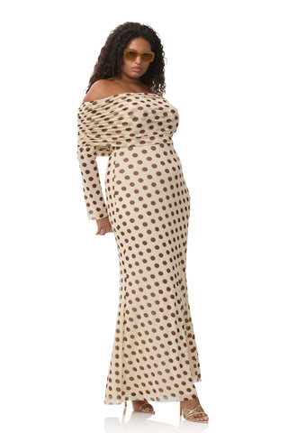 A non-pregnant lady wearing the AFRM Thelma Off Shoulder Mesh Maxi Dress in a photoshoot.