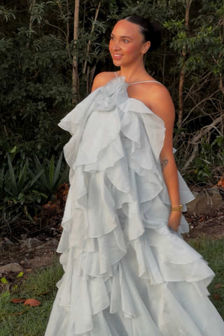 A pregnant lady wearing the Mama Rentals Aje Pandorea Layered Maxi Dress - Silver Blue.