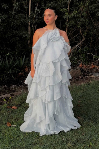 A pregnant lady wearing the Mama Rentals Aje Pandorea Layered Maxi Dress - Silver Blue.