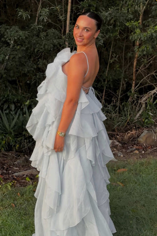 A pregnant lady wearing the Mama Rentals Aje Pandorea Layered Maxi Dress - Silver Blue.
