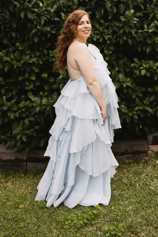 A pregnant lady wearing the Mama Rentals Aje Pandorea Layered Maxi Dress - Silver Blue side view.