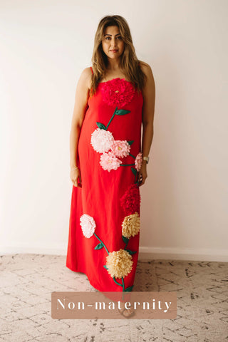 A lady wearing the Mama Rentals Elliatt Buttercup Embroidered Maxi Dress in a studio.