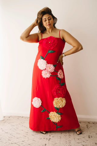 A lady wearing the Mama Rentals Elliatt Buttercup Embroidered Maxi Dress in a studio.
