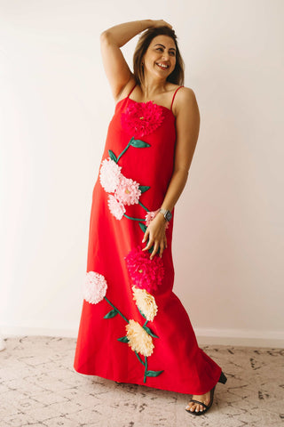 A lady wearing the Mama Rentals Elliatt Buttercup Embroidered Maxi Dress in a studio.