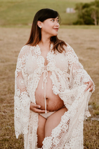 Bump shoot and maternity photoshoot wearing a cream lace crochet robe, the Mama Rentals Elvira Crochet Robe