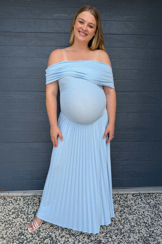 A pregnant lady wearing the Lioness Field of Dreams Maxi Dress in Soft Blue at her gender reveal event.