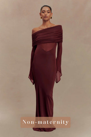 Woman wearing a burgundy off-shoulder gown against a beige background - The Mama Rentals Meshki Kaitlin One Shoulder Slinky and Mesh Maxi Dress Burgundy